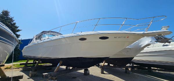Sea Ray 400 Express Cruiser 1999 Sea Ray 400 Express Cruiser boat on stands under clear blue sky.
