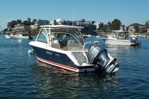 Pursuit DC 265 Dual Console 2013 Pursuit DC 265 Dual Console boat on calm water, surrounded by other boats.