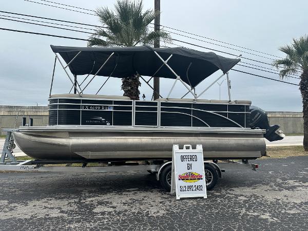 Bennington 218SLDN 2019 Bennington 218SLDN pontoon boat on trailer, black canopy, for sale sign displayed.