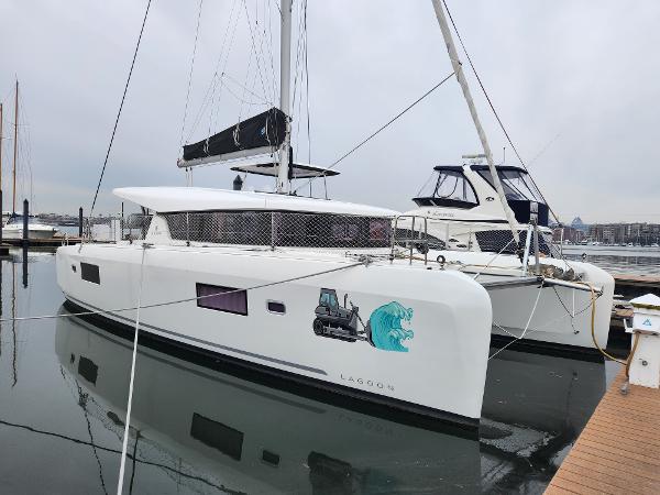 Lagoon 42 2020 Lagoon 42 catamaran docked at marina, featuring sleek design and modern amenities.