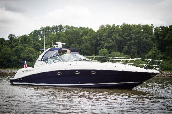 Sea Ray 420 Sundancer 2004 Sea Ray 420 Sundancer yacht cruising on a calm river with lush green trees.