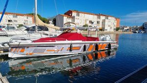 Axopar 37 Sun Top 2021 Axopar 37 Sun Top boat docked in a marina, featuring a red cover.