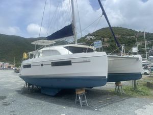 Leopard 40 2020 Leopard 40 catamaran on land, for sale, with scenic hillside background.