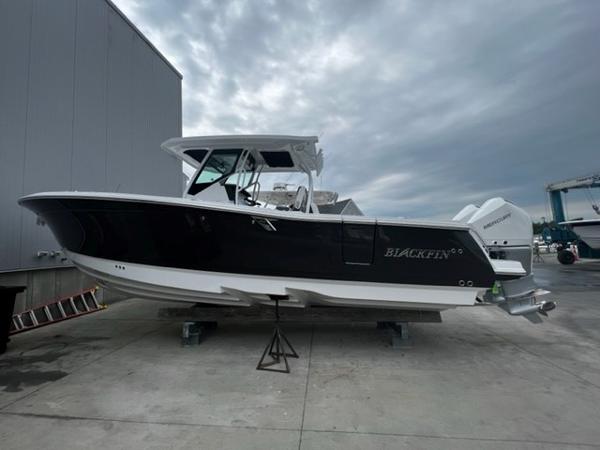 Blackfin 302 CC 2023 Blackfin 302 CC boat on a dock under cloudy skies.