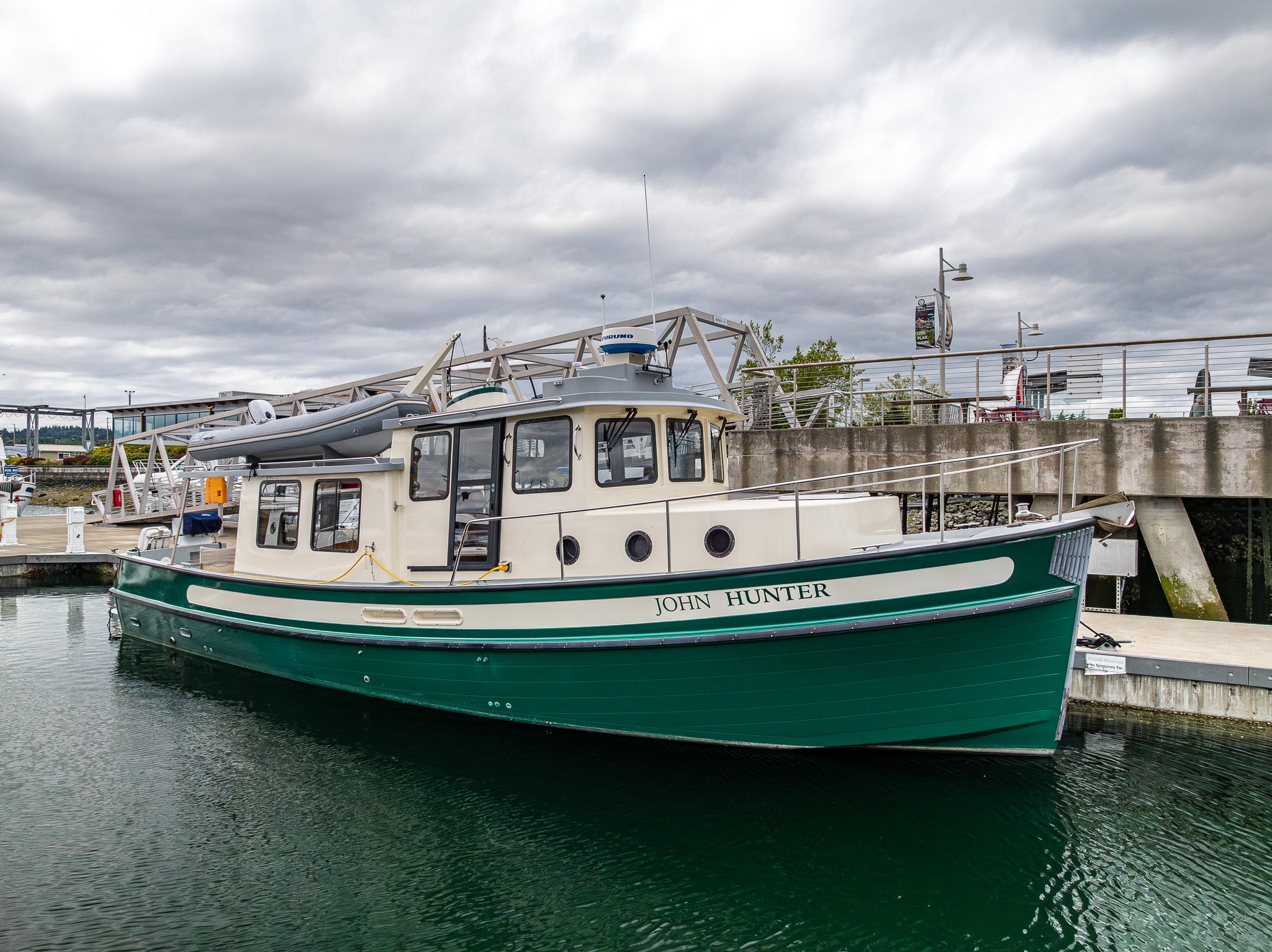 Nordic Tug 37 Nordic Tug 37, 2000 model, docked in a marina under cloudy skies.