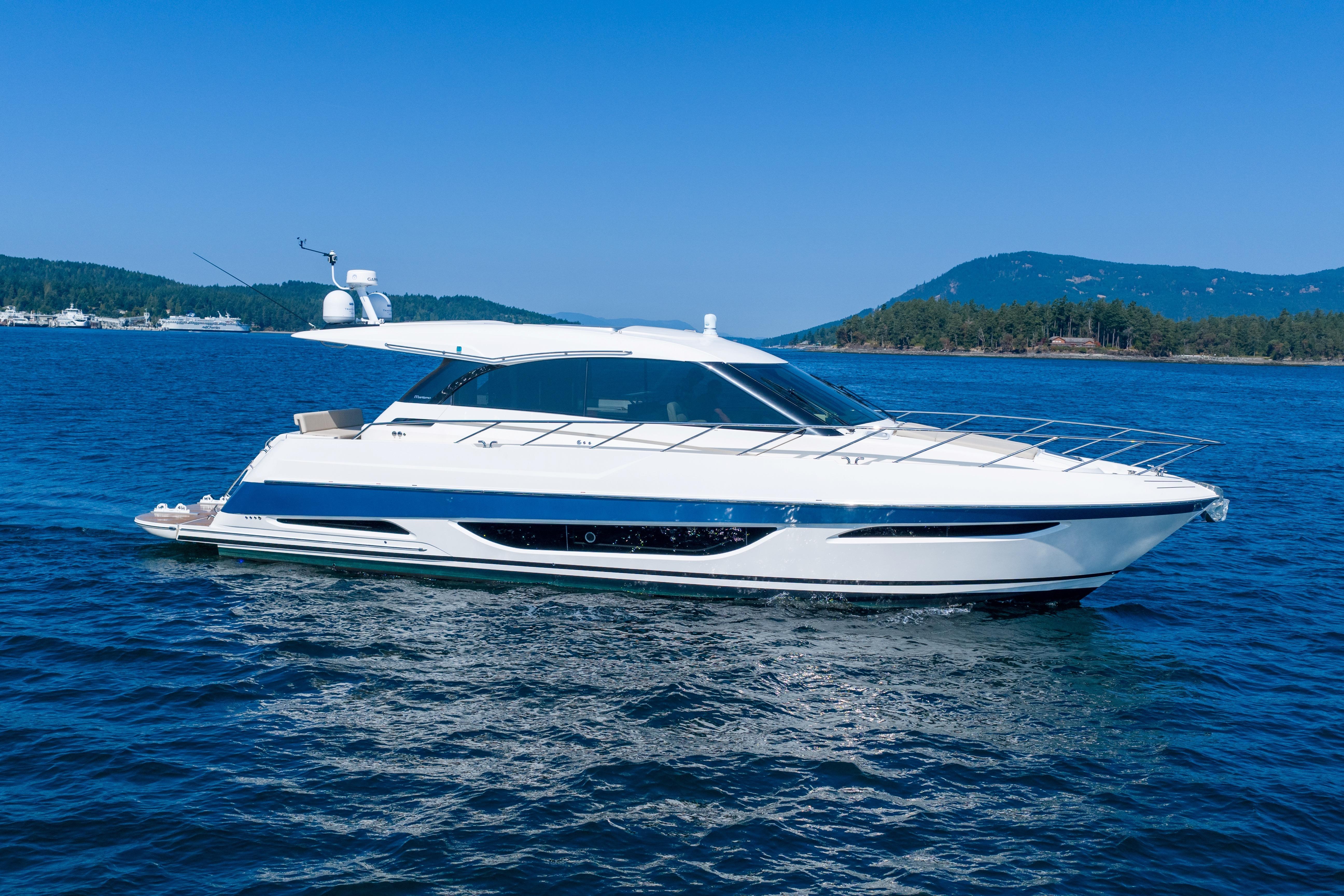 Maritimo X50 2021 Maritimo X50 yacht cruising on blue water with scenic mountain backdrop.