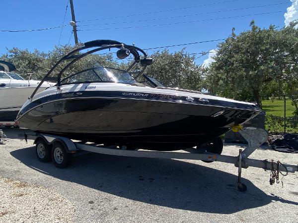 Yamaha Boats 242 Limited 2014 Yamaha Boats 242 Limited on a trailer, black hull, parked outdoors.