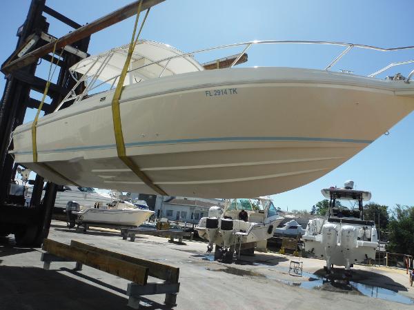 Intrepid 339 Walkaround 1996 Intrepid 339 Walk Around boat lifted at marina, side view.