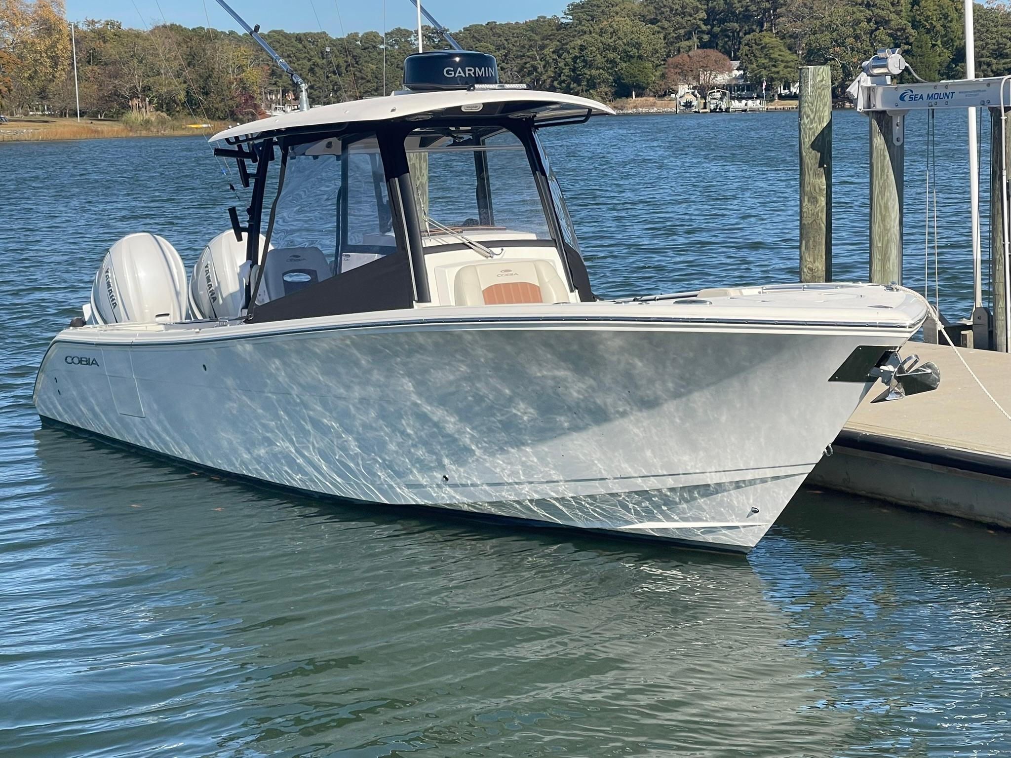 Cobia 320 CC 2023 Cobia 320 CC boat docked on a sunny day.
