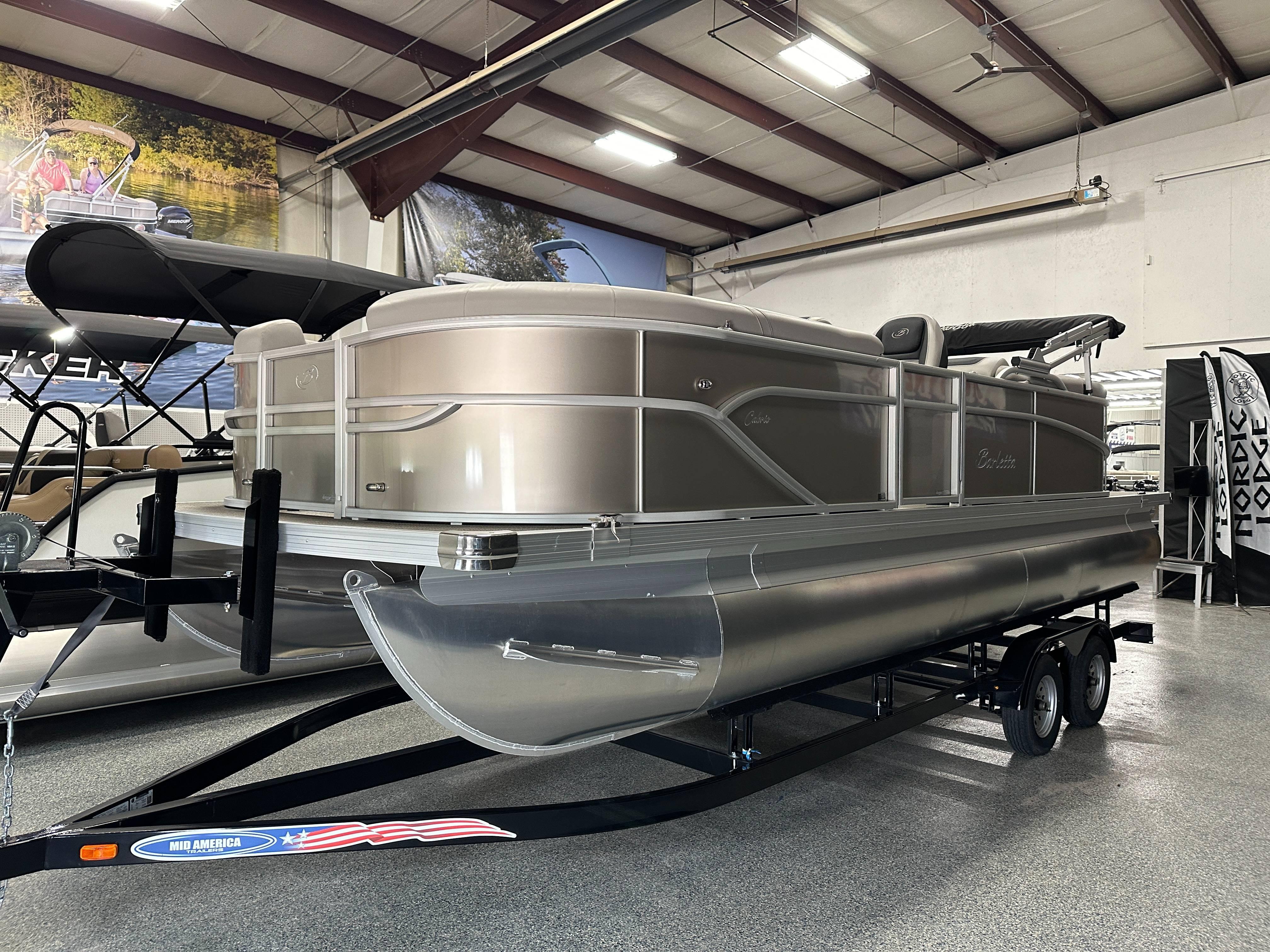 Barletta Cabrio 22QC 2025 Barletta Cabrio 22QC pontoon boat displayed indoors on a trailer.