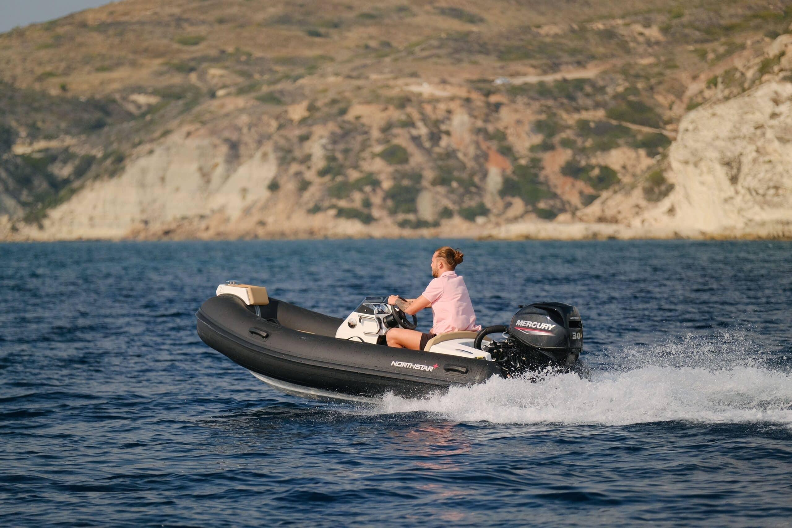 Northstar Axis 3.1 2025 Northstar Axis 3.1 boat cruising on blue water near rocky coastline.