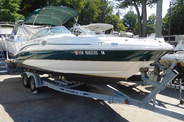 Sea Ray 240 Sundeck 2002 Sea Ray 240 Sundeck boat on trailer, green and white, parked outdoors.