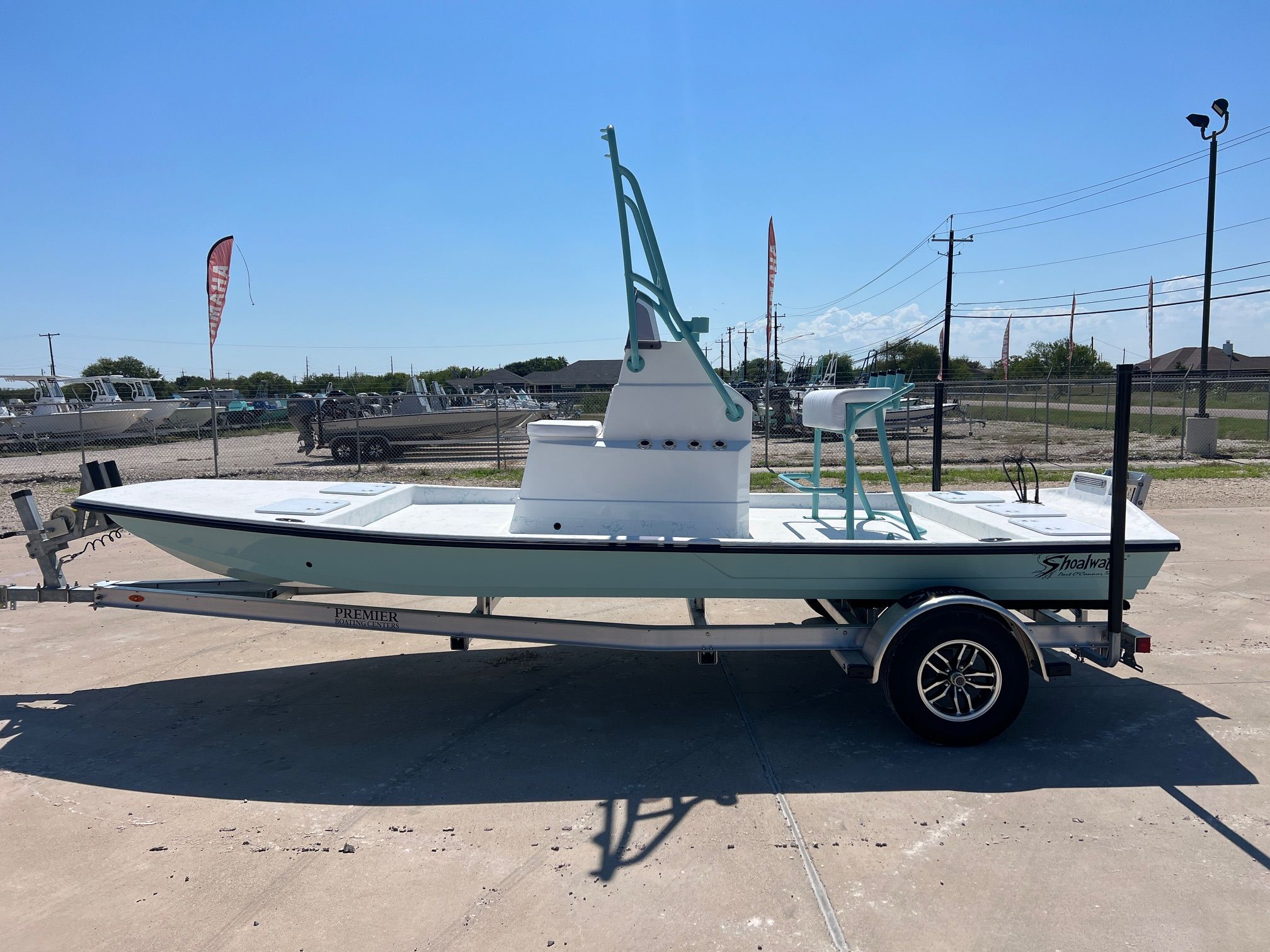 Shoalwater 19 Cat 2026 Shoalwater 19 CAT boat on trailer, parked outdoors under clear sky.