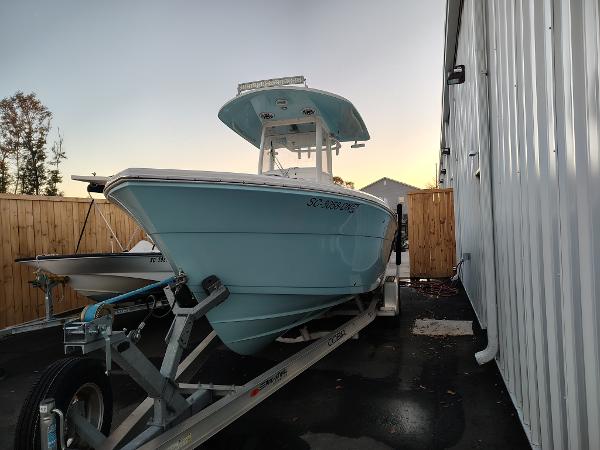 Cobia 240 Center Console 2020 Cobia 240 Center Console boat on trailer beside building at sunset.