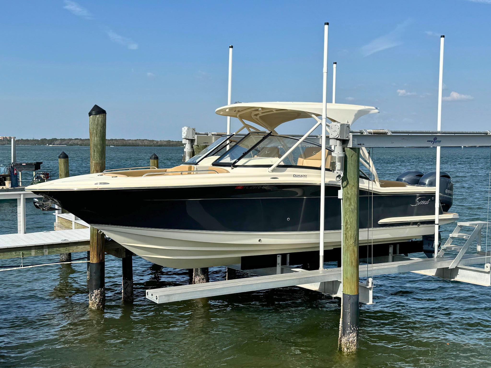 Scout 255 Dorado 2021 Scout 255 Dorado boat on lift by the water.
