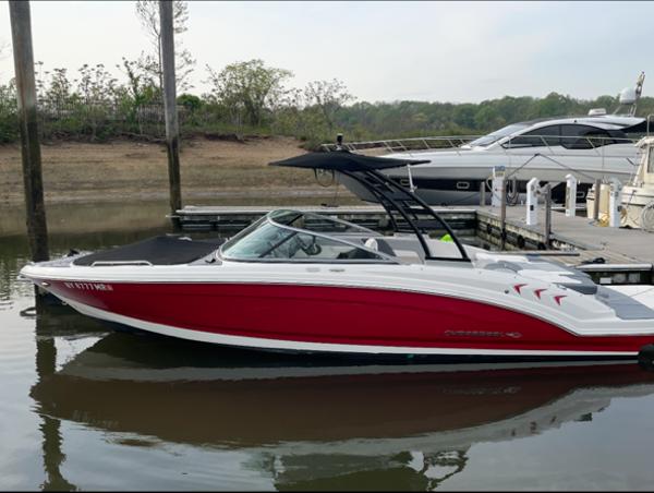 Chaparral 23 SSi 2021 Chaparral 23 SSi boat with red hull docked at marina.