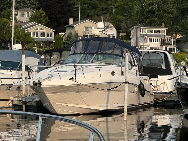 Sea Ray 340 Sundancer 2007 Sea Ray 340 Sundancer docked at marina with waterfront homes in background.