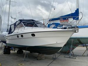 Princess 286 Riviera 1990 Princess Riviera 286 boat for sale, docked on land, with overcast sky.
