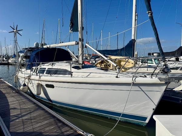 Hunter 340 Sailboat docked at marina, Hunter 340 model, year 2000, with clear blue sky.