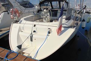 Dufour DUFOUR 36 CLASSIC 2003 Dufour 36 Classic sailboat docked, featuring a French flag and spacious cockpit.