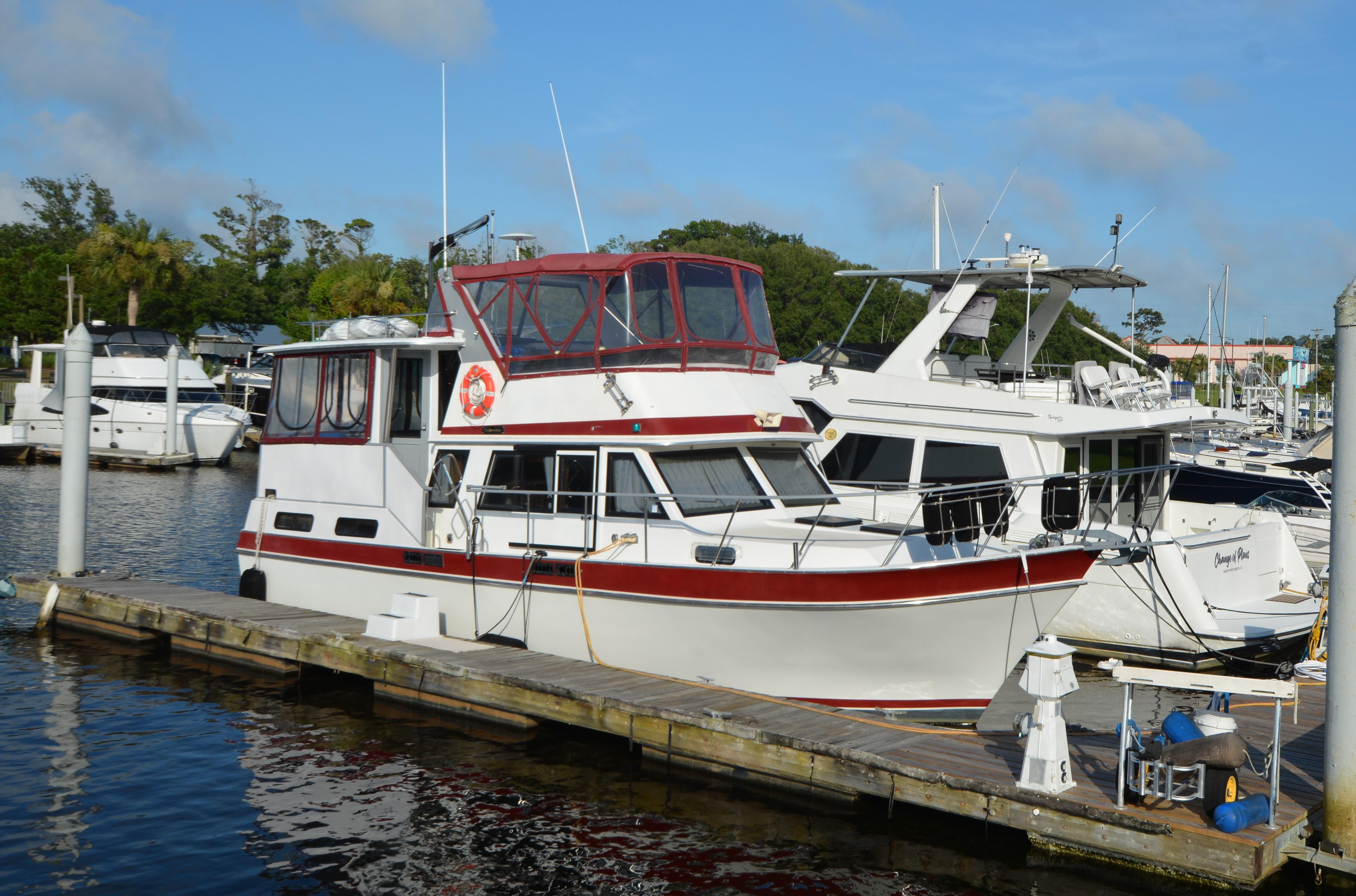 Californian 38 Motor Yacht 1983 Californian 38 Motor Yacht docked at marina under clear blue sky.