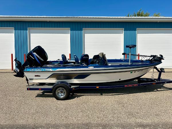 Skeeter WX 1880 2005 Skeeter WX 1880 boat on trailer, parked in front of blue garage doors.