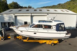 Nimbus 365 Coupe 2019 Nimbus 365 Coupe boat on trailer outside industrial building.