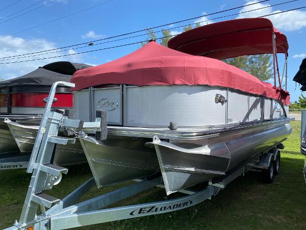 Manitou oasis 2021 Manitou Oasis pontoon boat with red cover on EZ Loader trailer.