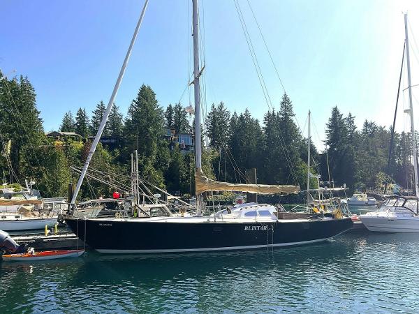 Custom Bill Tripp Custom Bill Tripp 1969 sailboat docked in a serene marina setting.