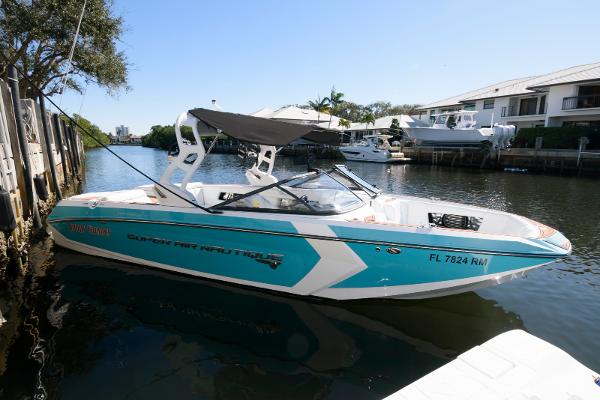 Nautique Super Air Nautique G25 2017 Nautique Super Air Nautique G25 boat docked in a sunny canal.