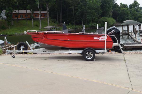 Stabicraft 1550 Frontier Profish 2025 Stabicraft 1550 Frontier Profish boat on trailer by lakeside dock.