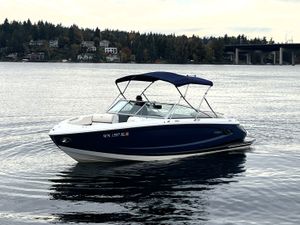 Cobalt A25 2017 Cobalt A25 boat on calm water with scenic forested background.