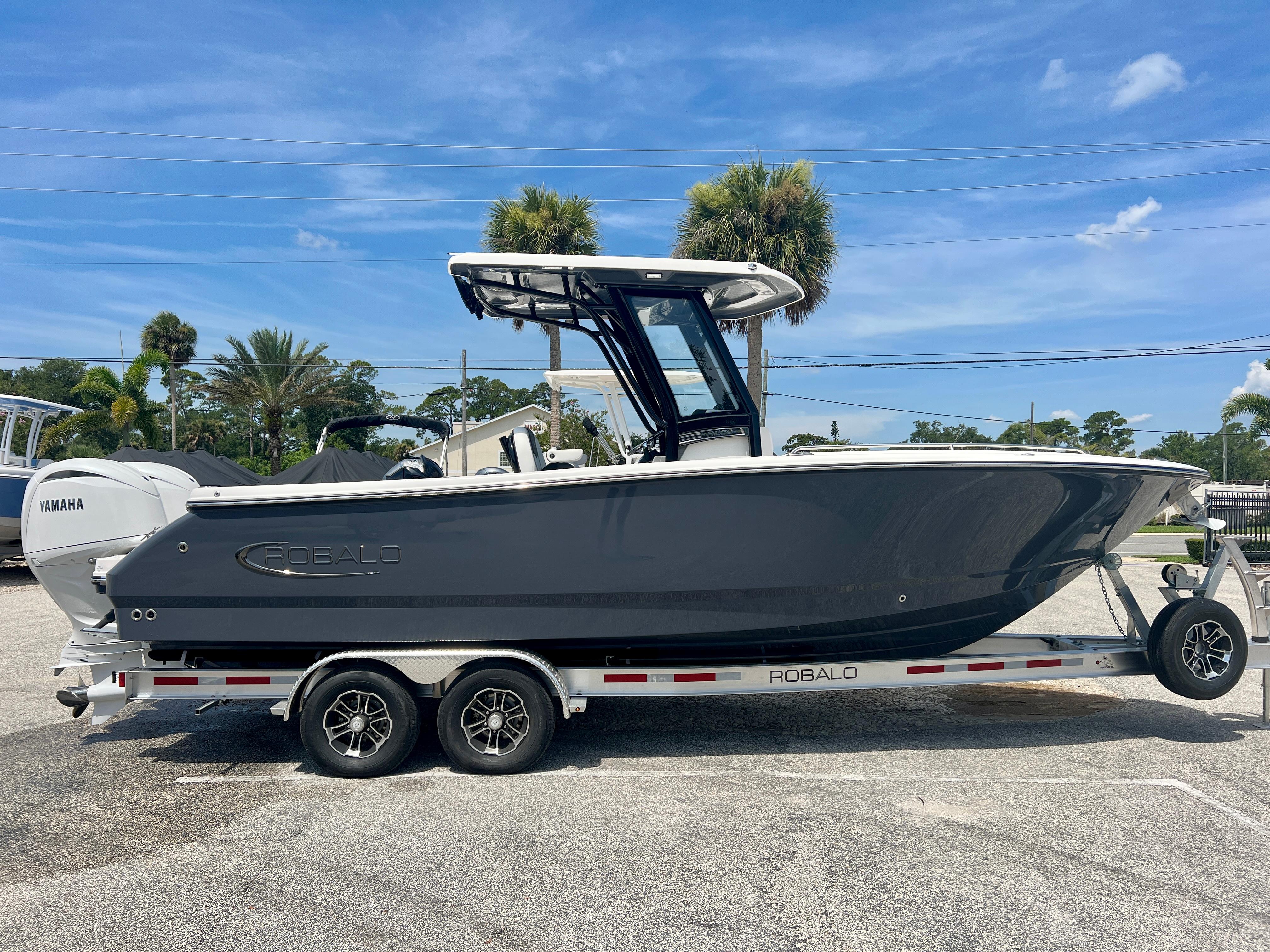 Robalo R250 2025 Robalo R250 boat on a trailer with Yamaha engine, parked outdoors.