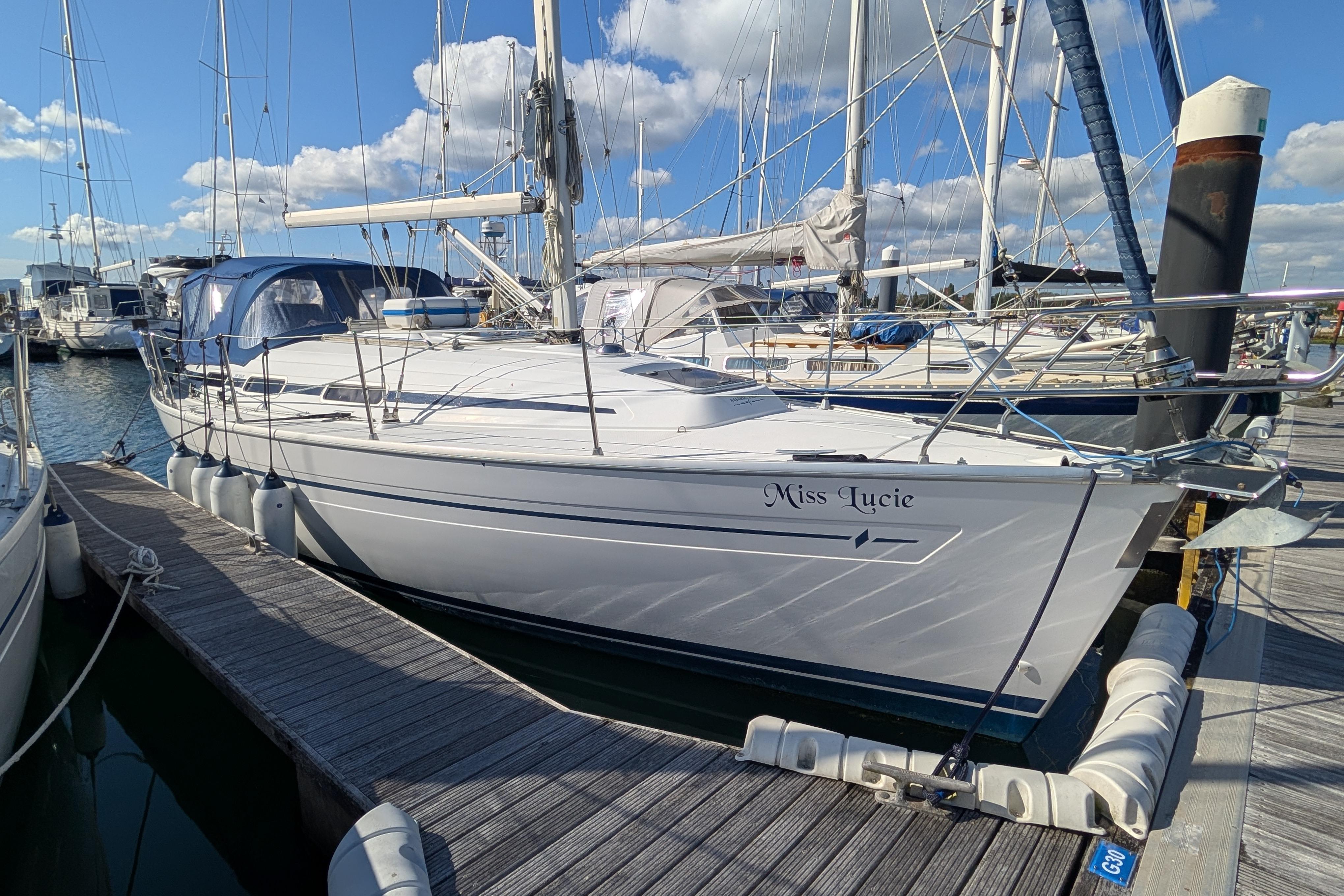 Bavaria 32 Cruiser 2003 Bavaria 32 Cruiser sailboat docked at marina under blue sky.