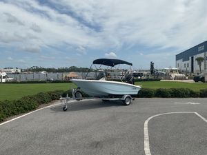 Boston Whaler 13 Super Sport 2024 Boston Whaler 13 Super Sport boat on trailer, parked near marina.