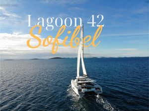 Lagoon 42 Sailing catamaran Lagoon 42, 2019 model, cruising on open sea under clear blue sky.