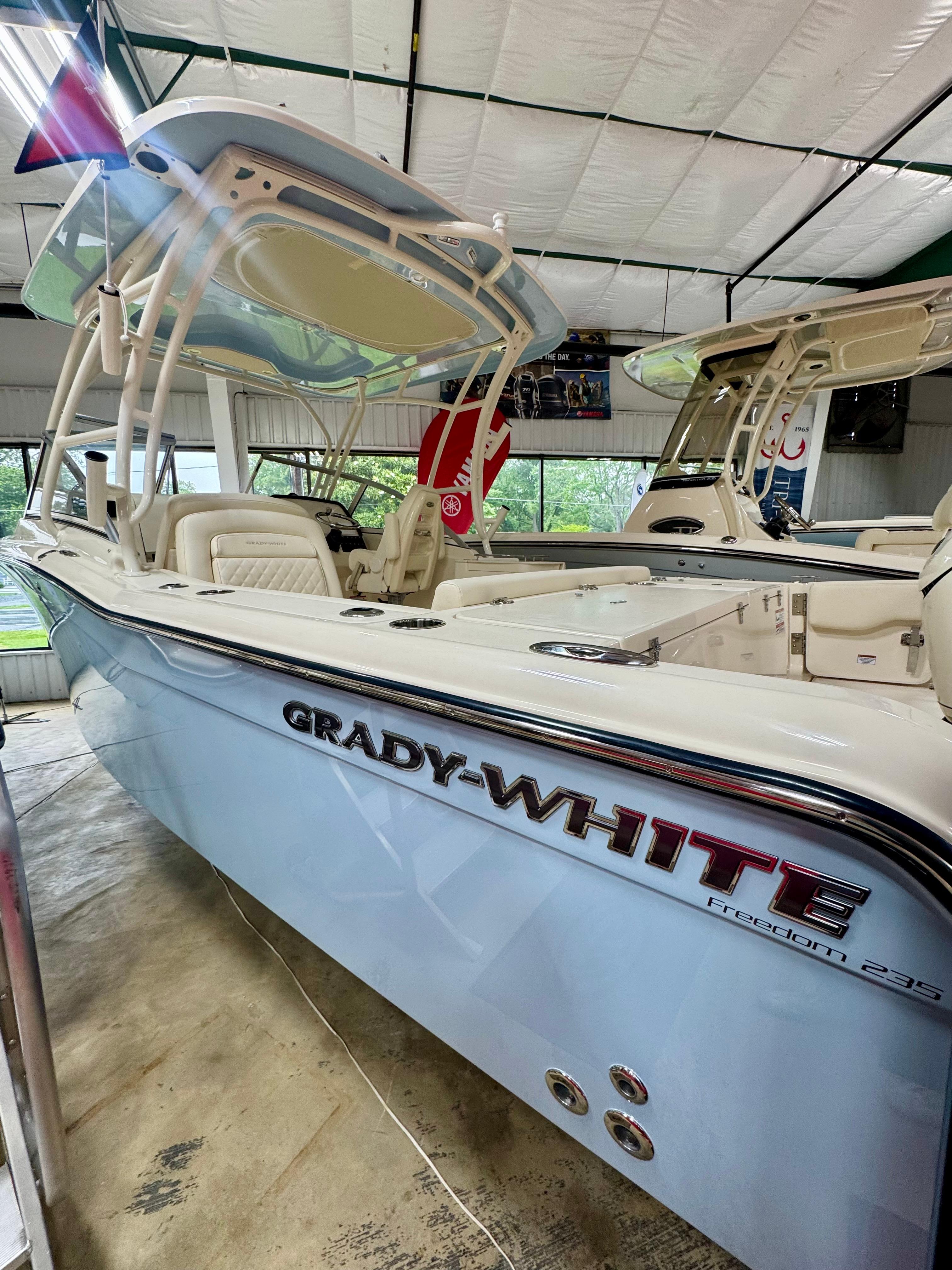 Grady-White Freedom 235 2025 Grady-White Freedom 235 boat in showroom, side view.