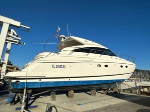 Princess V53 2007 Princess V53 yacht on dry dock, white hull, blue stripe, clear sky background.