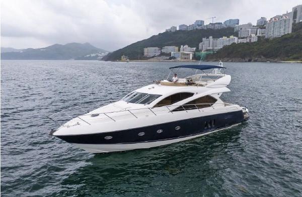 Sunseeker Manhattan 60 2007 Sunseeker Manhattan 60 yacht cruising near coastal cityscape.