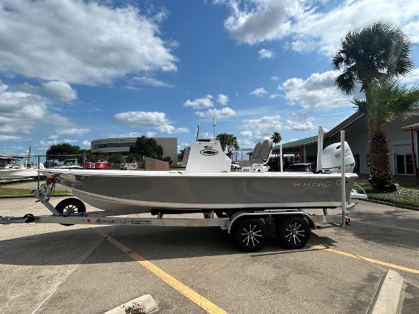 Sea Pro 230 Bay 2025 Sea Pro 230 Bay boat on trailer under a partly cloudy sky.