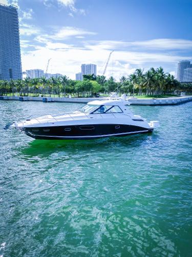 Sea Ray 450 Sundancer 2010 Sea Ray 450 Sundancer yacht cruising in a tropical marina.