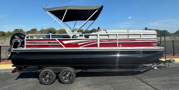 Ranger Reata 220FC 2023 Ranger Reata 220FC pontoon boat with canopy on trailer, side view.
