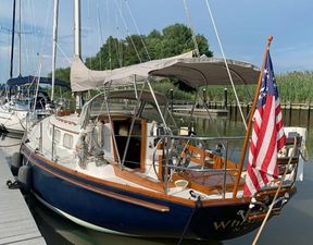 Bristol 40 1981 Bristol 40 sloop docked, featuring classic design and American flag.