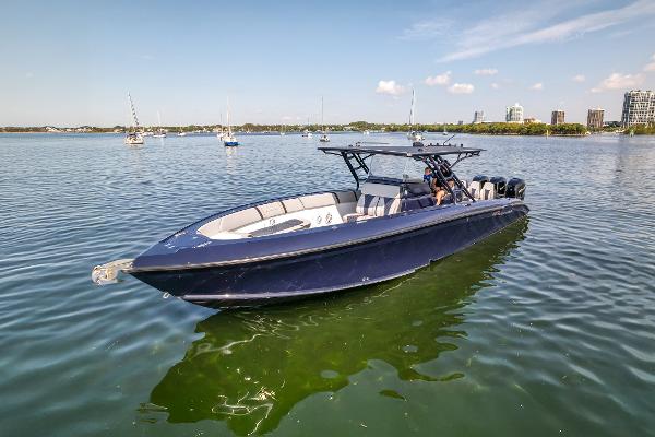 Midnight Express 37’ Open 2014 Midnight Express 37’ Open boat on calm water, cityscape in background.