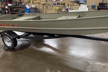 Tracker Grizzly 15 Jon 2026 Tracker Grizzly 15 Jon boat on trailer in a workshop setting.