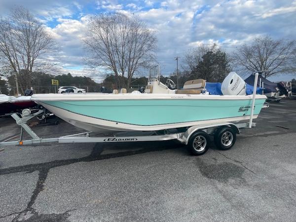 Carolina Skiff 21 Ultra Elite 2023 Carolina Skiff 21 Ultra Elite boat on trailer, parked outdoors.