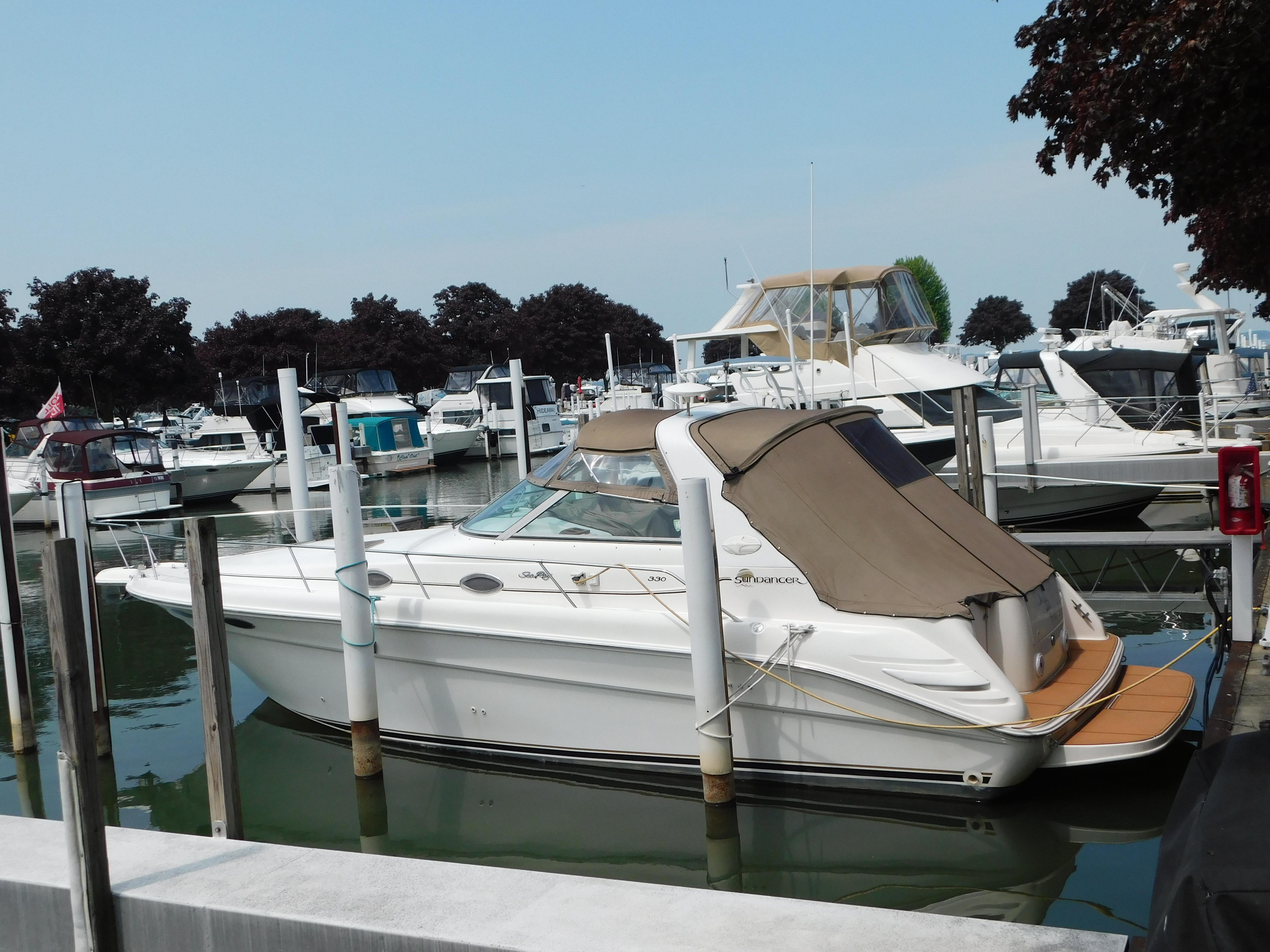Sea Ray 330 Sundancer 1997 Sea Ray 330 Sundancer docked at a marina, surrounded by other boats.