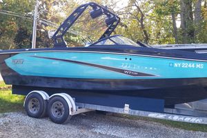Heyday WTSurf 2021 Heyday WTSurf boat on trailer, vibrant blue and black design, parked outdoors.