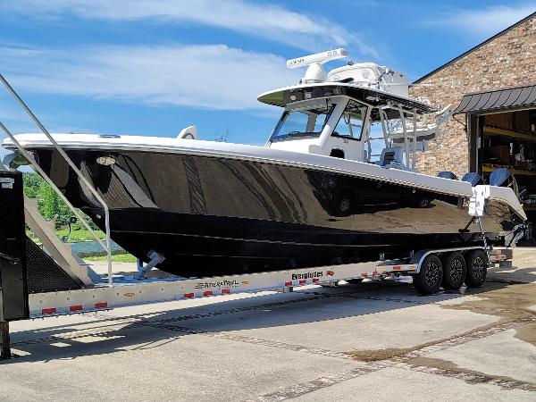 Everglades 355 Tournament 2015 Everglades 355 Tournament boat on trailer, sleek black hull, parked outdoors.