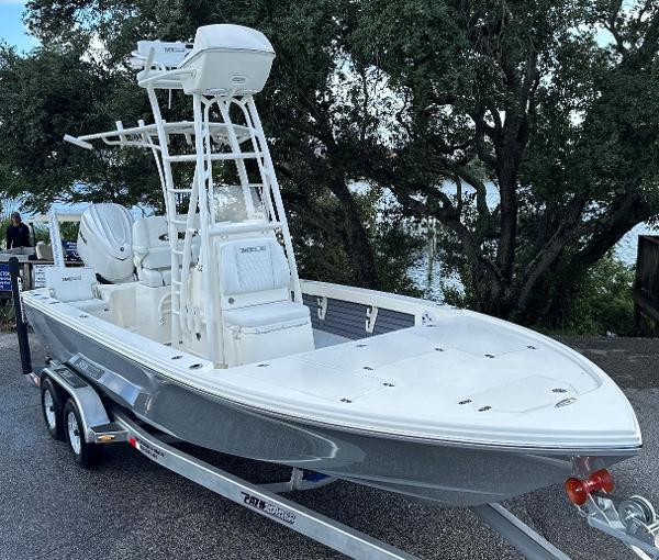 Pathfinder 2500 Hybrid 2025 Pathfinder 2500 Hybrid boat on trailer, parked near trees.
